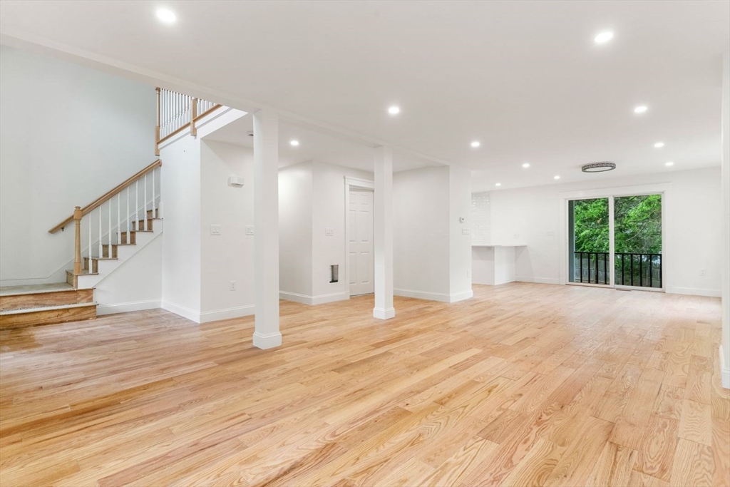 20 Dudley Road Wayland, MA 01778 - Photo 6 of 27 a view of an empty room with wooden floor and a window