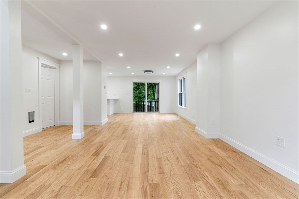 20 Dudley Road Wayland, MA 01778 - Photo 9 of 27 a view of an empty room with wooden floor and a window