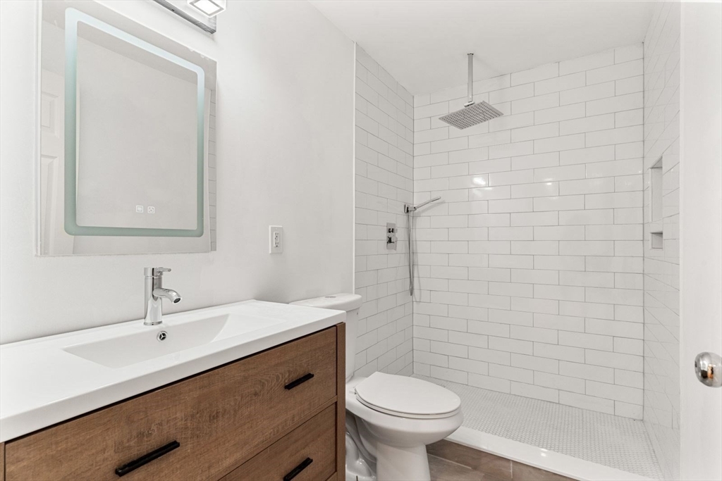20 Dudley Road Wayland, MA 01778 - Photo 10 of 27 a bathroom with a sink a toilet and shower