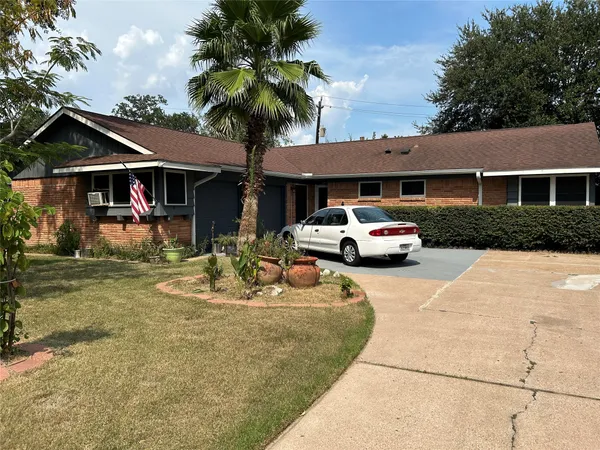 a car parked in front of house with a yard