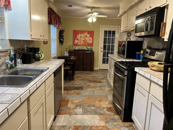 a kitchen with a stove and a microwave