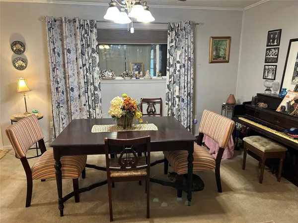 a view of a dining room with furniture and chandelier