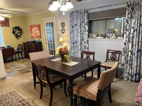 a view of a dining room with furniture and chandelier