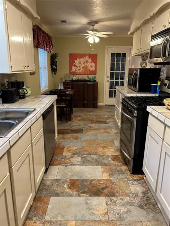 a kitchen with a sink stove and refrigerator