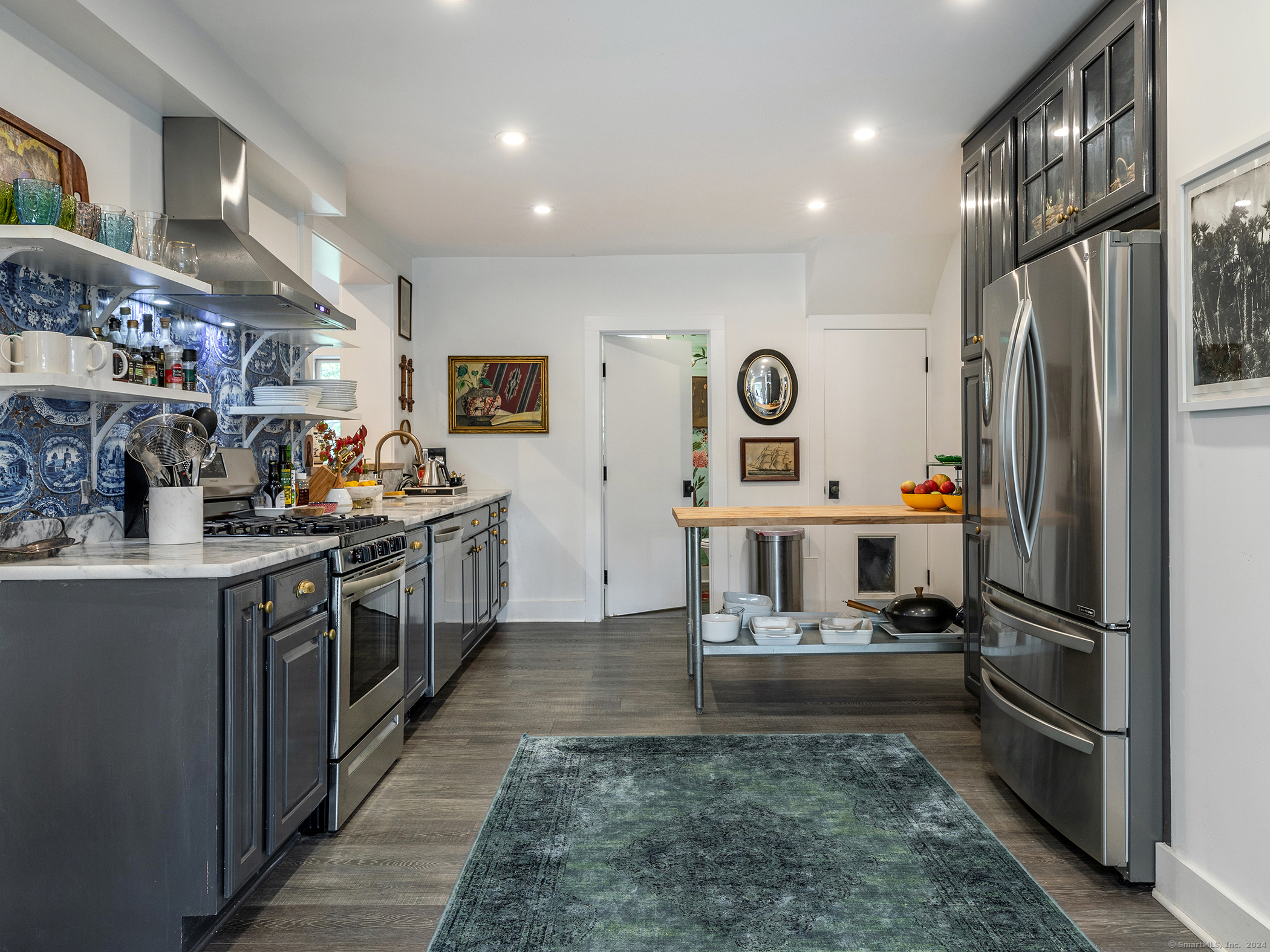 379 Lake Road Warren, CT 06777 - Photo 11 of 36 a kitchen with stainless steel appliances kitchen island granite countertop a refrigerator a stove top oven and a sink