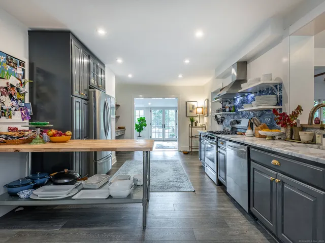 a kitchen with a sink appliances and cabinets