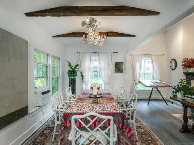 a living room with furniture flowers and a chandelier