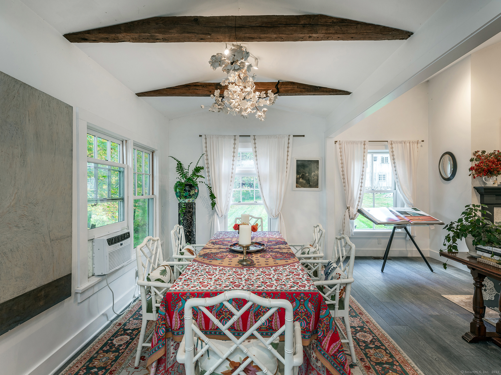 379 Lake Road Warren, CT 06777 - Photo 13 of 36 a living room with furniture flowers and a chandelier