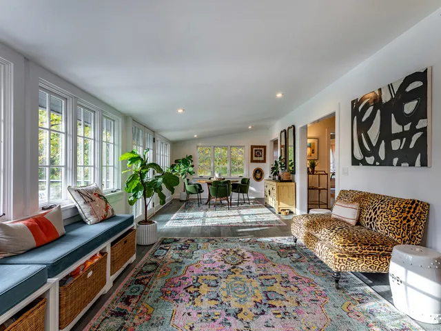 a living room with furniture and a potted plant