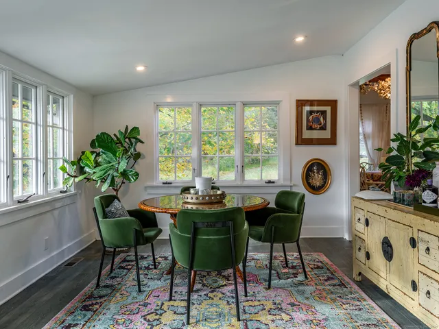 a dining room with furniture and window