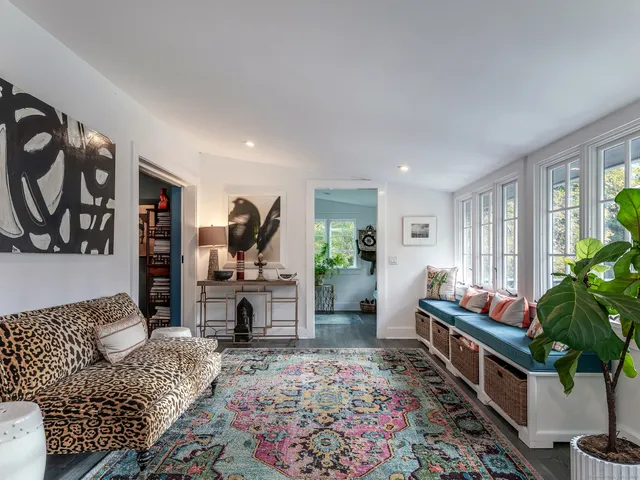 a living room with furniture potted plant and a fireplace