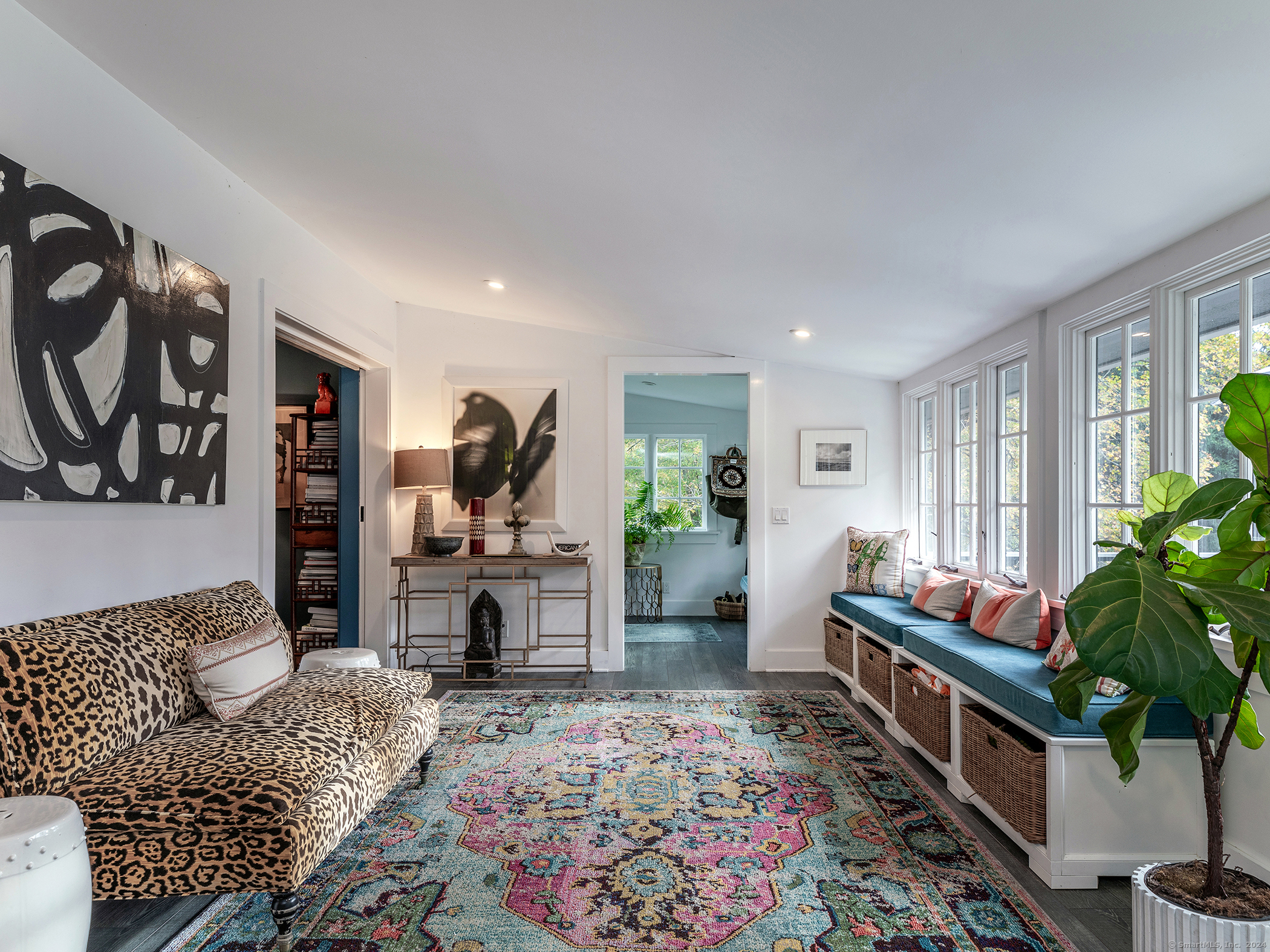 379 Lake Road Warren, CT 06777 - Photo 17 of 36 a living room with furniture potted plant and a fireplace