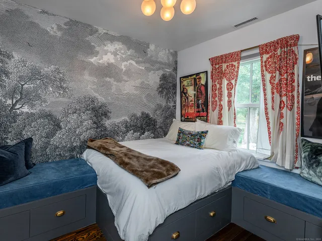 a bedroom with a bed and a flat screen tv