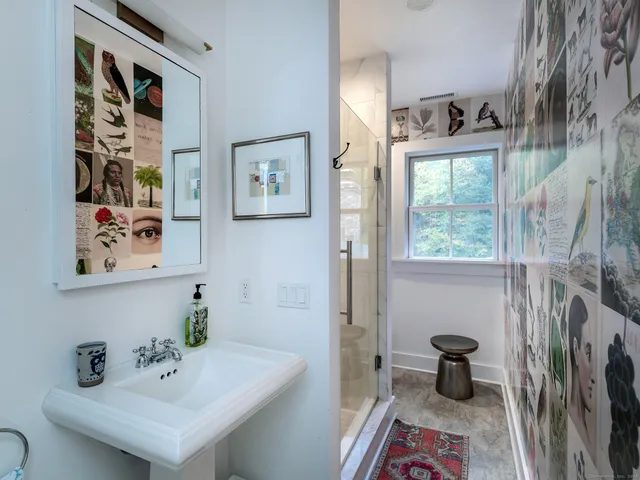 a bathroom with a sink toilet and a window