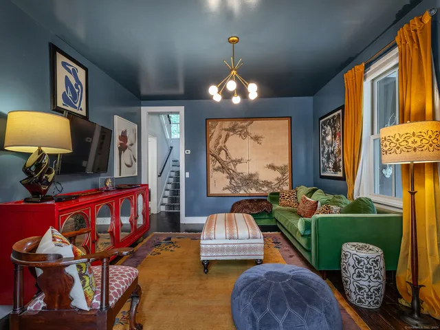 a living room filled with furniture and a chandelier