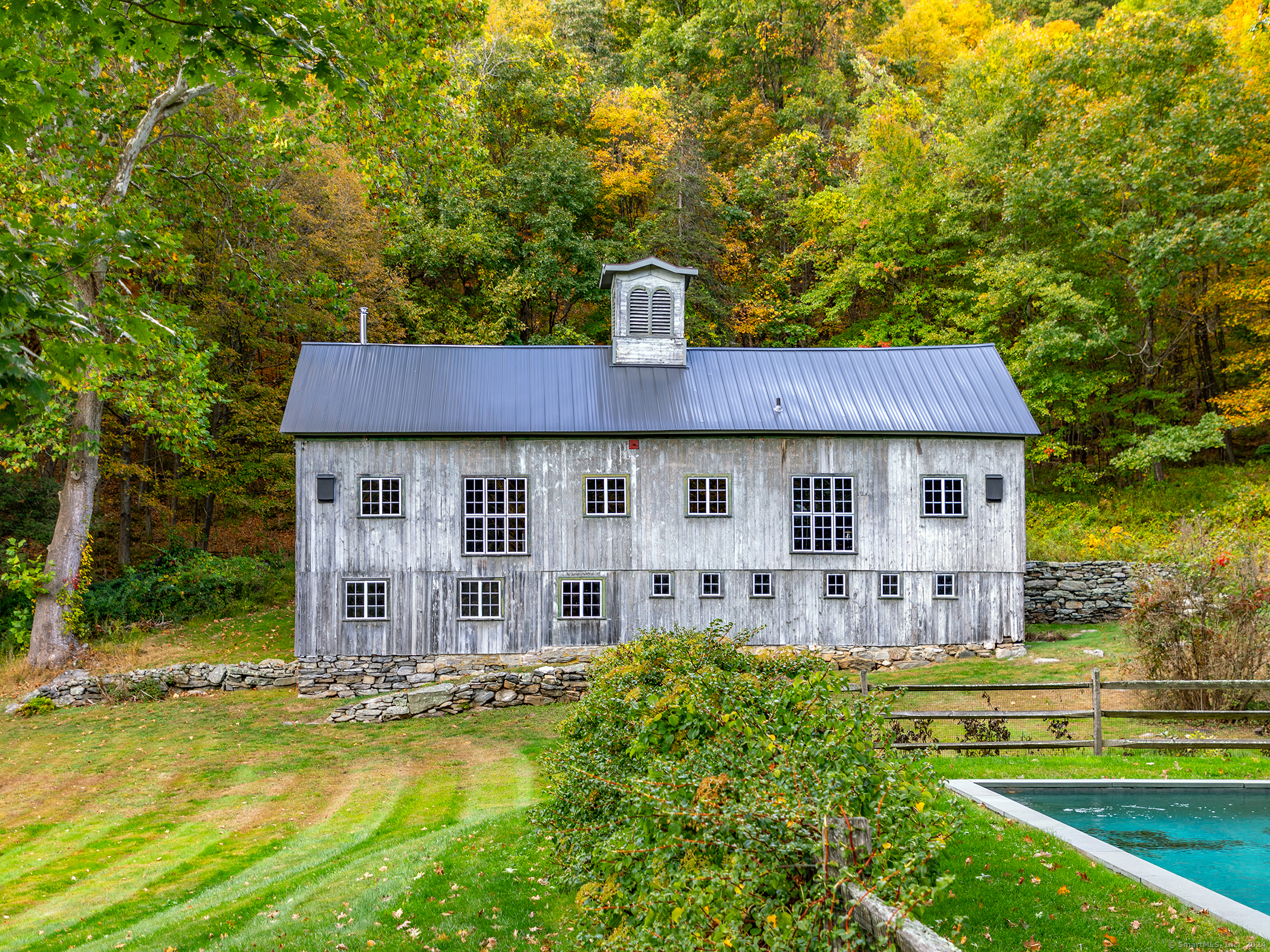 379 Lake Road Warren, CT 06777 - Photo 33 of 36 a view of a house with a yard balcony and sitting area