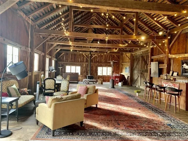 a living room with lots of furniture and a chandelier