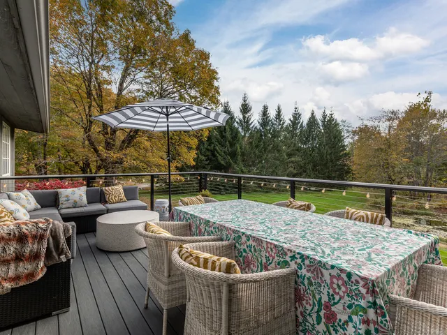 a terrace with outdoor seating and trees