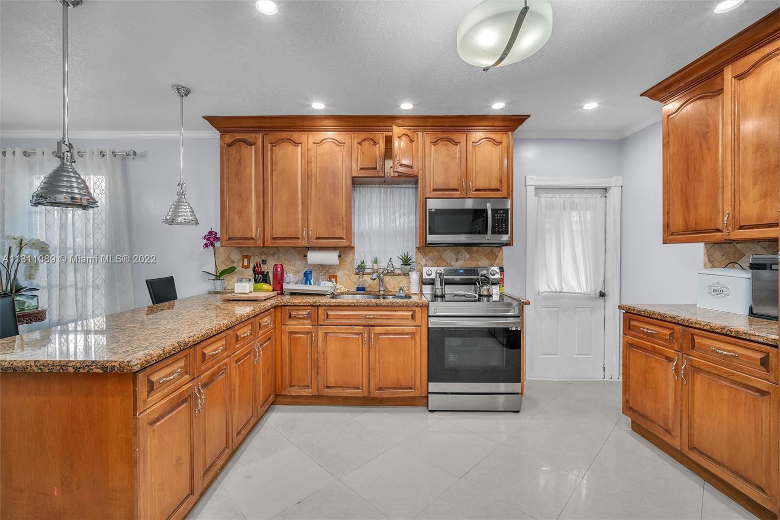 Allapattah Miami, FL 33125 - Photo 12 of 37 a kitchen with stainless steel appliances granite countertop a sink and stove