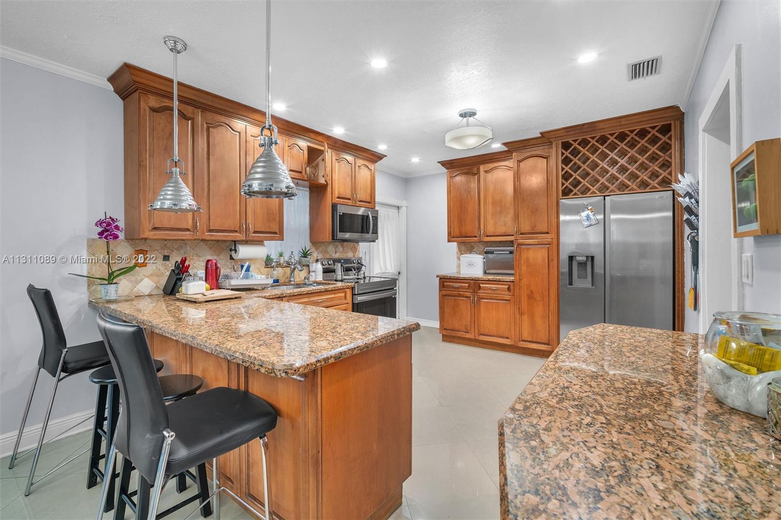 Allapattah Miami, FL 33125 - Photo 13 of 37 a kitchen with stainless steel appliances kitchen island granite countertop a sink refrigerator and cabinets