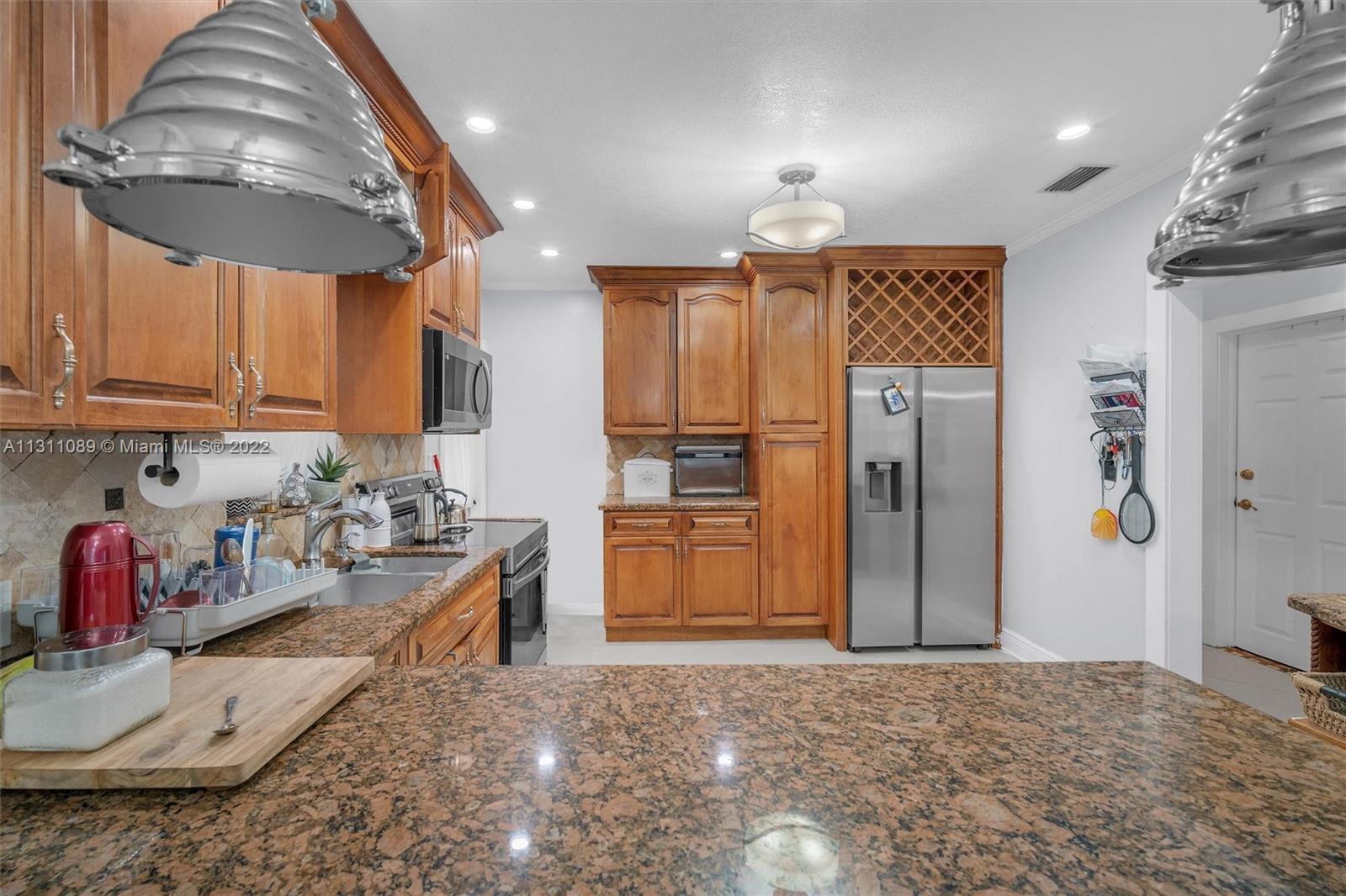 Allapattah Miami, FL 33125 - Photo 17 of 37 a view of a kitchen with refrigerator and cabinets