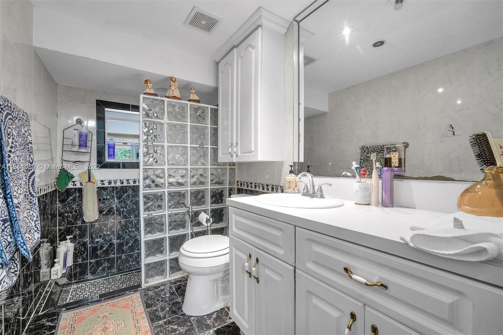 Allapattah Miami, FL 33125 - Photo 19 of 37 a bathroom with a sink a toilet and shower