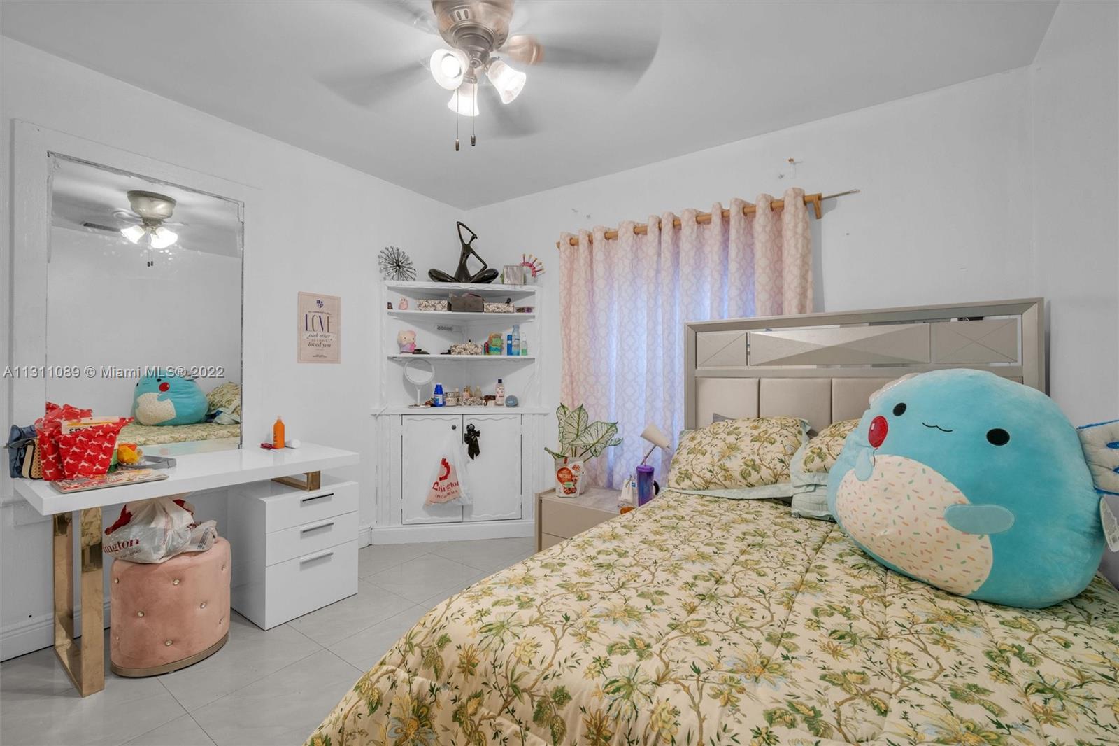 Allapattah Miami, FL 33125 - Photo 20 of 37 a bedroom with a bed and a chandelier