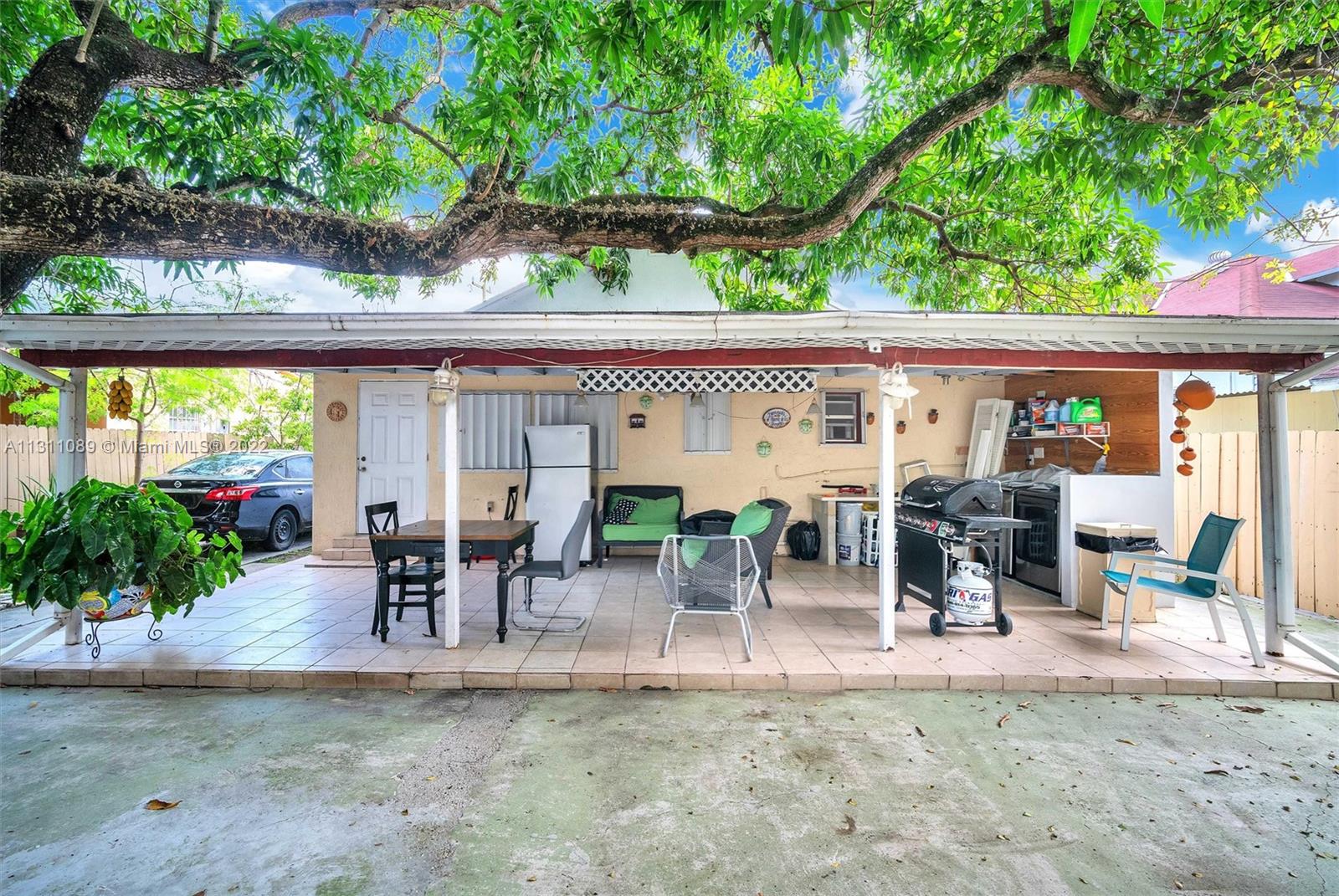 Allapattah Miami, FL 33125 - Photo 37 of 37 a view of a patio with table and chairs potted plants and floor to ceiling window