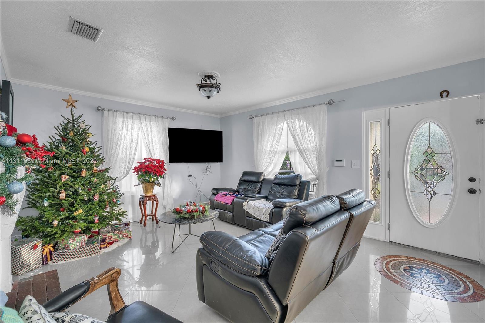 Allapattah Miami, FL 33125 - Photo 7 of 37 a living room with furniture and a flat screen tv