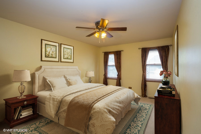 67 Bright Ridge Drive Schaumburg, IL 60194 - Photo 12 of 16 a bedroom with a bed and a chandelier