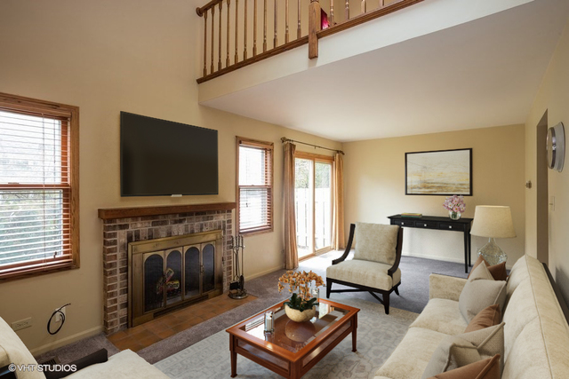 67 Bright Ridge Drive Schaumburg, IL 60194 - Photo 5 of 16 a living room with furniture a flat screen tv and a fireplace