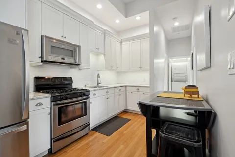 a kitchen with a stove a sink and a refrigerator
