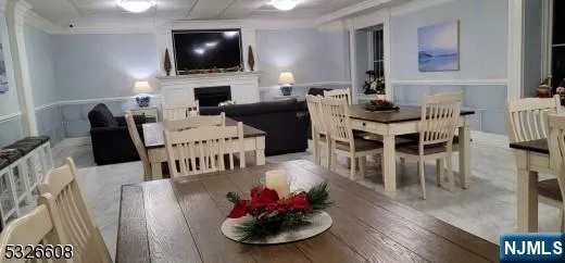 a living room with furniture a flat screen tv and kitchen view