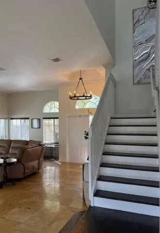 a view of a livingroom with furniture and staircase
