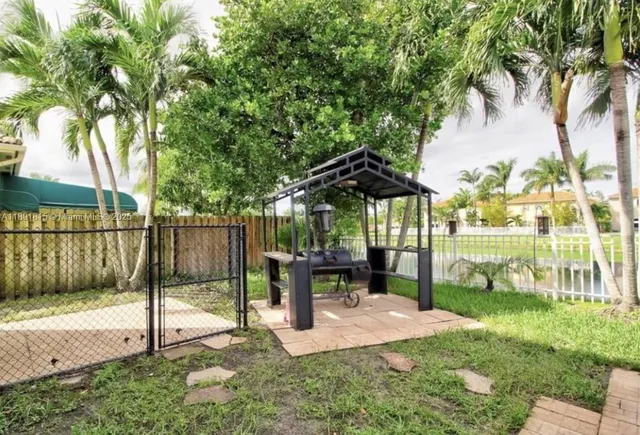 a view of a park with iron fence