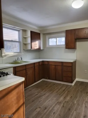 a kitchen with stainless steel appliances granite countertop a sink stove and wooden floor