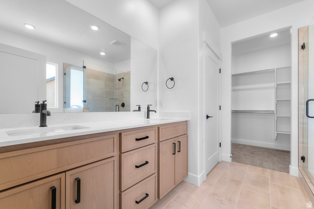 1341 West 2350 South, Unit 10 Perry, UT 84302 - Photo 11 of 18 Dual vanity with light wood-finish cabinetry, white countertops, and matte black fixtures
