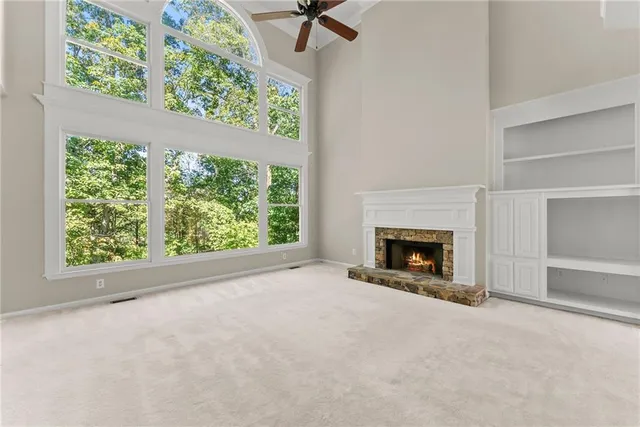 a view of an empty room with a fireplace