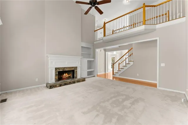 a view of an empty room with windows and outdoor space