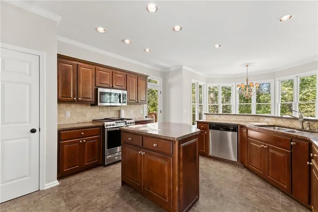 a kitchen with granite countertop a stove and a refrigerator
