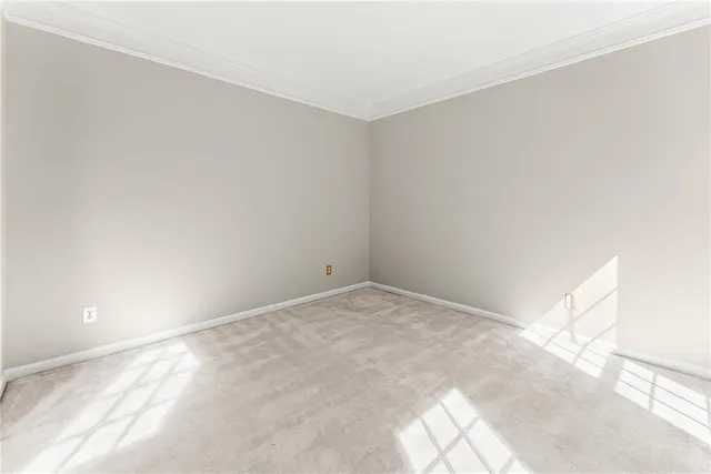 an empty room with windows and ceiling fan view