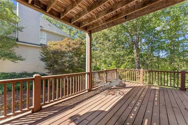an empty room with a ceiling fan and carpet