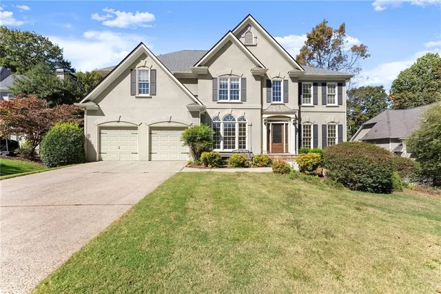 a front view of a house with a yard and garage