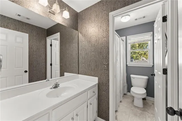 a view of a dining room with furniture and a large window