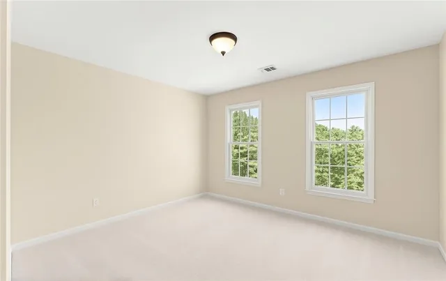 a view of a dining room with furniture and windows