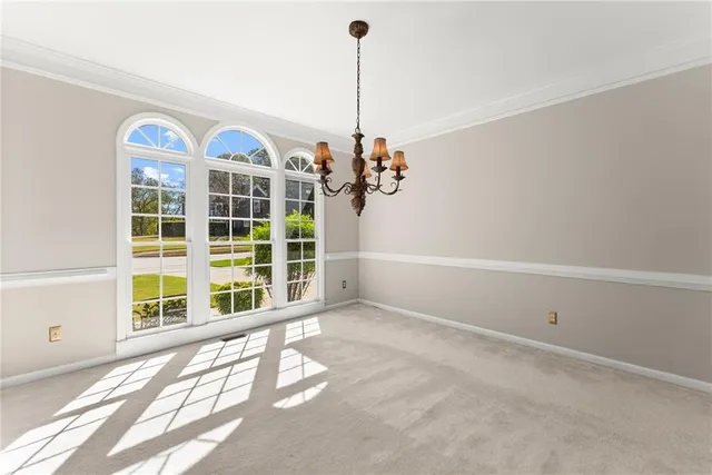 a view of a room with window and chandelier