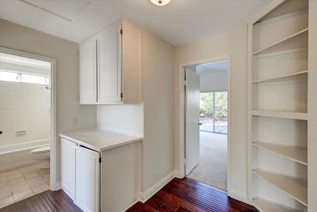 a view of an empty room and wooden floor