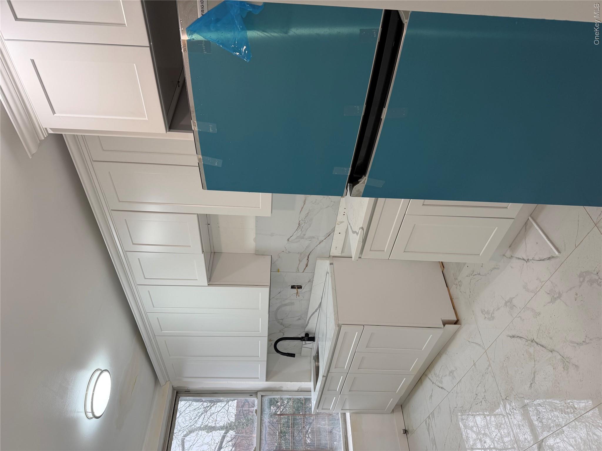 70 Howard Avenue Brooklyn, NY 11221 - Photo 2 of 8 a kitchen with a refrigerator and cabinets