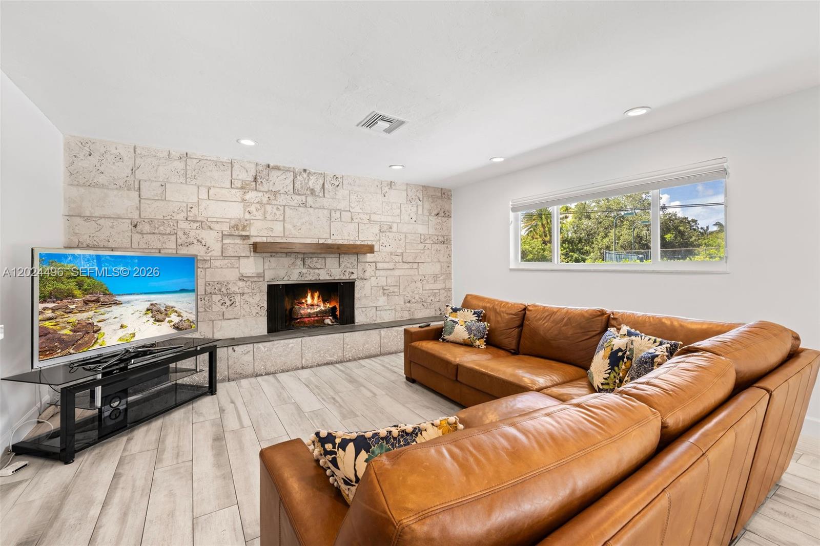 6875 North Cartee Road Palmetto Bay, FL 33158 - Photo 20 of 42 a living room with furniture and a fireplace