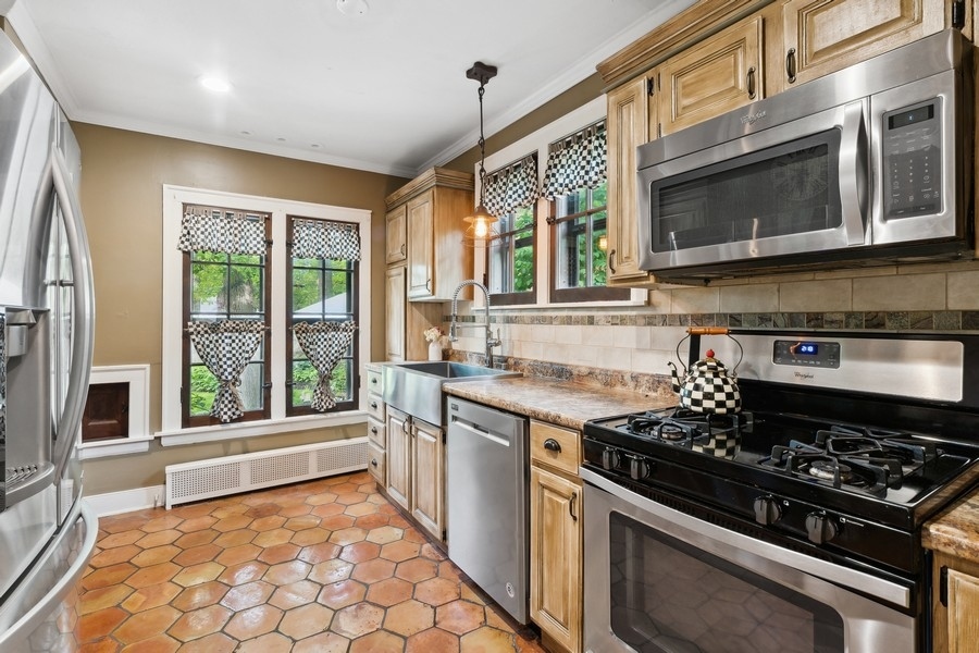 357 Sumac Road Highland Park, IL 60035 - Photo 8 of 23 a kitchen with a stove a sink and a microwave